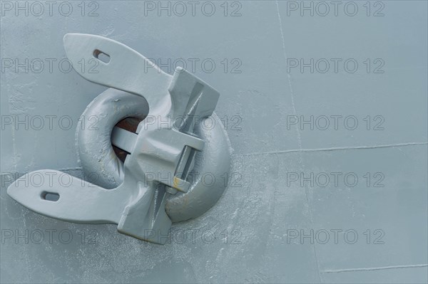 Large metal anchor on side on navel battleship in dry dock in Yeosu, South Korea, Asia