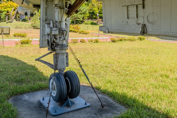 Front landing gear and bay door on jet fighter on display in public park