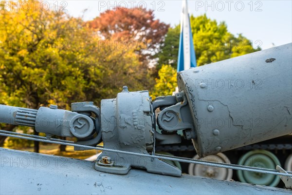 Closeup of intermediate gear box and u-joints of connecting tail rotor drive shaft on helicopter on display at public park