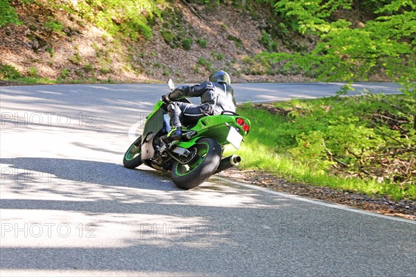 Sporty motorcyclist on a trip into the countryside (Edenkoben Valley, Palatinate Forest)