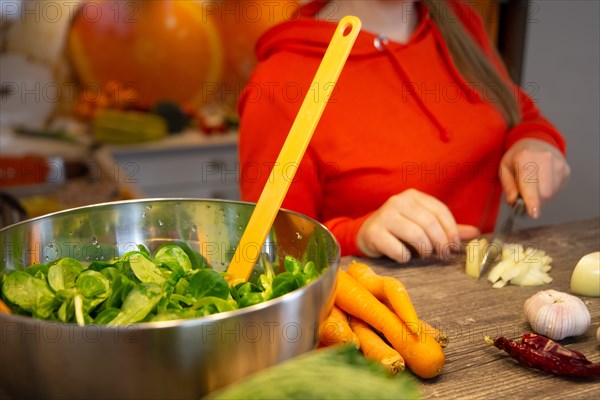 Vegan cooking: Young woman prepares lamb's lettuce