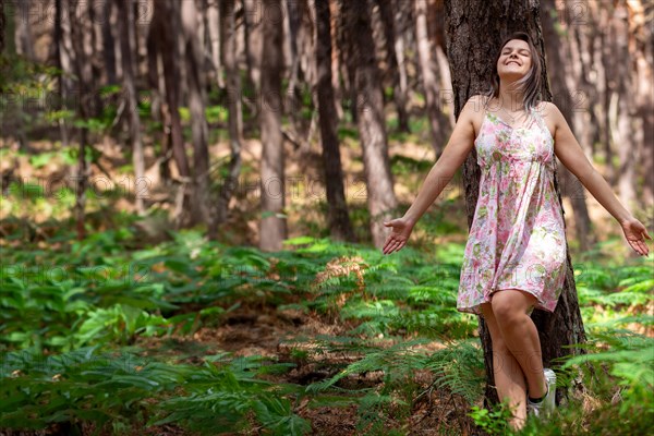 Young woman bathing in the forest (Shinrin Yoku), nature therapy from Japan