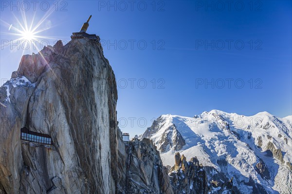 Mountain station and mountain peak with glacier in sunlight, backlight, fisheye, view of Aiguille du Midi and Mont Blanc, Mont Blanc massif, French Alps, Chamonix, France, Europe