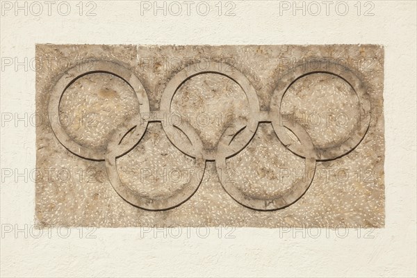 Olympic rings at the Olympic Stadium, 1936 venue of the Winter Games, torchbearer, Garmisch-Partenkirchen, Upper Bavaria, Bavaria, Germany, Europe