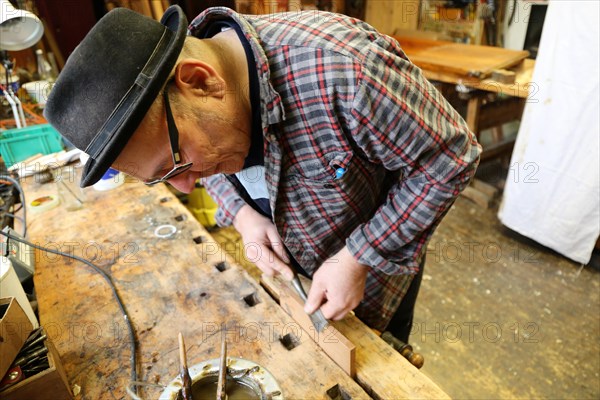 Furniture restorer in his workshop