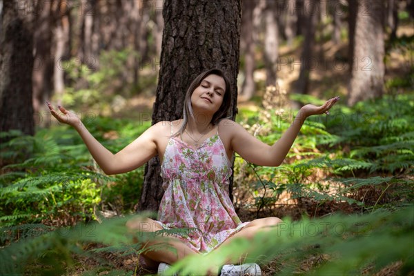 Young woman bathing in the forest (Shinrin Yoku), nature therapy from Japan