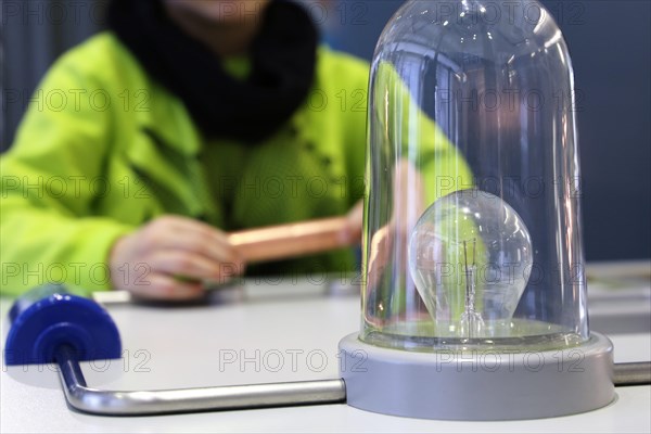 Child conducting a physics experiment with a simple circuit