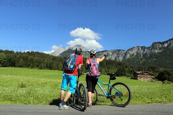 Mountain bikers enjoy the panorama from the Wilder Kaiser