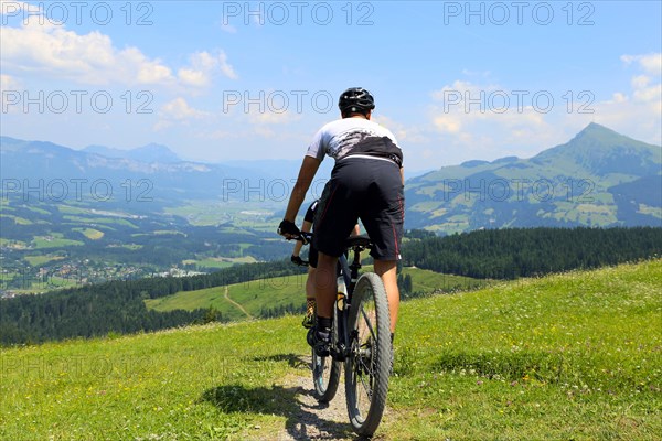 Mountain bikers in the Kitzbuehel Alps with alternating views of the Wilder Kaiser and the Kitzbueheler Horn