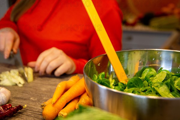 Vegan cooking: Young woman prepares lamb's lettuce