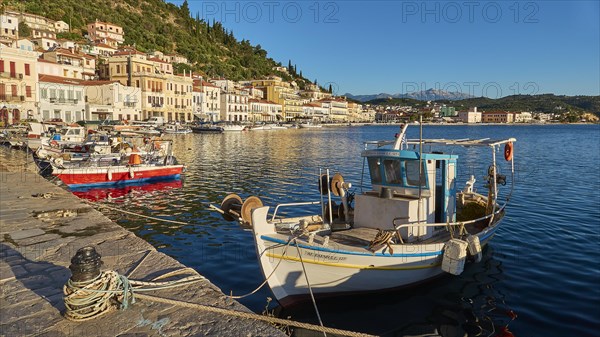 Quiet harbour with boats in front of picturesque coastal town and mountains in the background, Taygetos Mountains, Taygetos, Gythio, Mani, Peloponnese, Greece, Europe