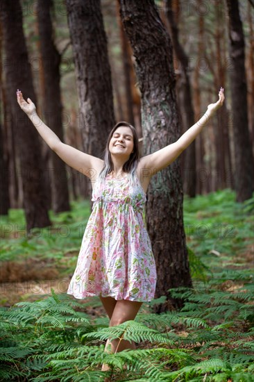 Young woman bathing in the forest (Shinrin Yoku), nature therapy from Japan