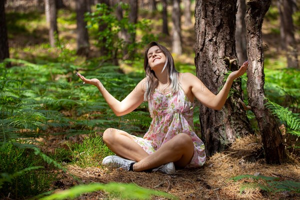 Young woman bathing in the forest (Shinrin Yoku), nature therapy from Japan