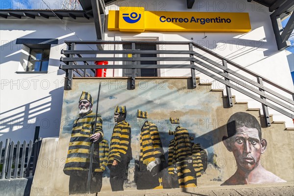 Graffito with men in convict clothing as a reminder of the historic penal colony on the post office building, Ushuaia, Tierra del Fuego Island, Patagonia, Argentina, South America