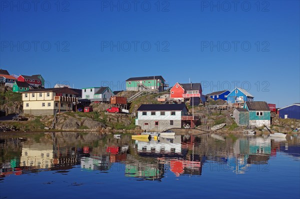 Colourful houses reflected in the calm waters of the fjord, Maniitsoq, Greenland, Denmark, North America