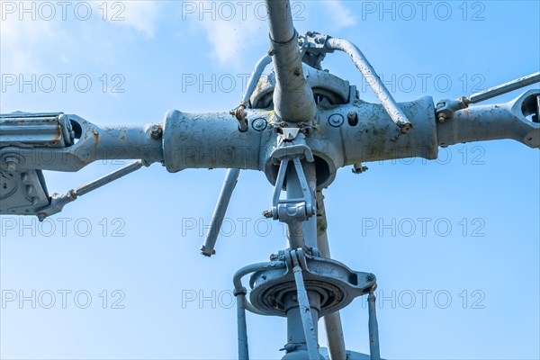 Helicopter main rotor assembly of aircraft on display in public park with blue sky in background