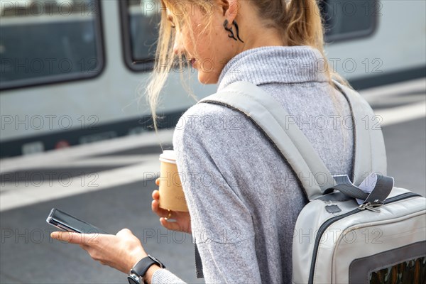 Young woman at a railway station waiting for the train