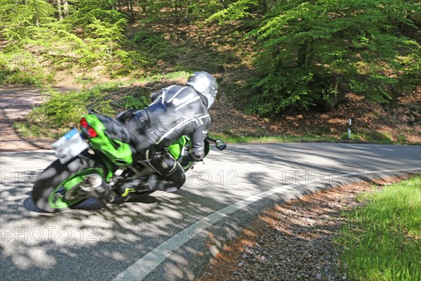 Sporty motorcyclist on a trip into the countryside (Edenkoben Valley, Palatinate Forest)