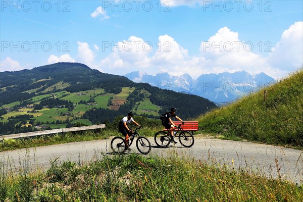 Mountain bikers in the Kitzbuehel Alps with alternating views of the Wilder Kaiser and the Kitzbueheler Horn