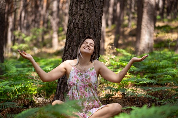 Young woman bathing in the forest (Shinrin Yoku), nature therapy from Japan