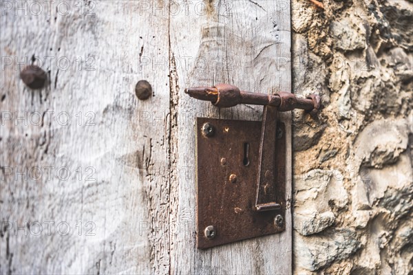 Detail of a bolt on a wooden door of a medieval house in Rupit in Catalonia in Spain