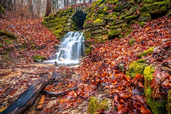 Waterfall in the Rautal forest in Jena in winter, Jena, Thuringia, Germany, Europe