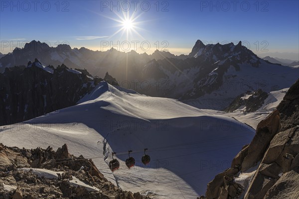 Mountain railway in front of glacier and mountains, sunbeams, backlight, Aiguille du Midi, Mont Blanc massif, French Alps, Chamonix, France, Europe