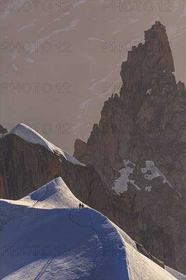 Mountaineer on glacier at sunrise, Mont Blanc Massif, French Alps, Chamonix, France, Europe