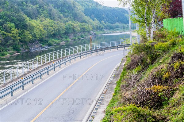 Two lane country road beside river