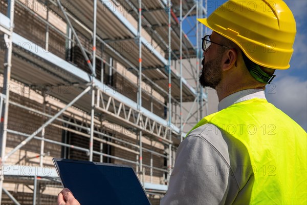 Symbolic image: Architect in front of an apartment block under construction