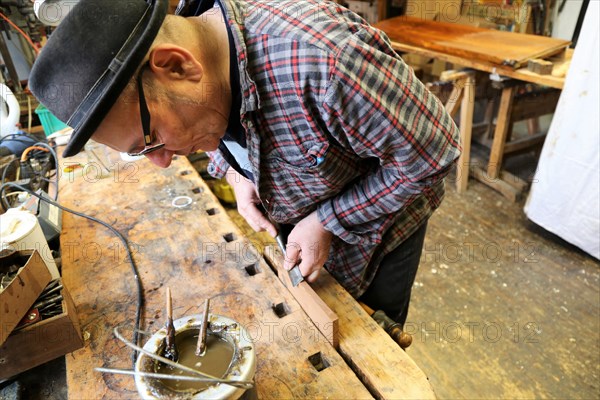 Furniture restorer in his workshop