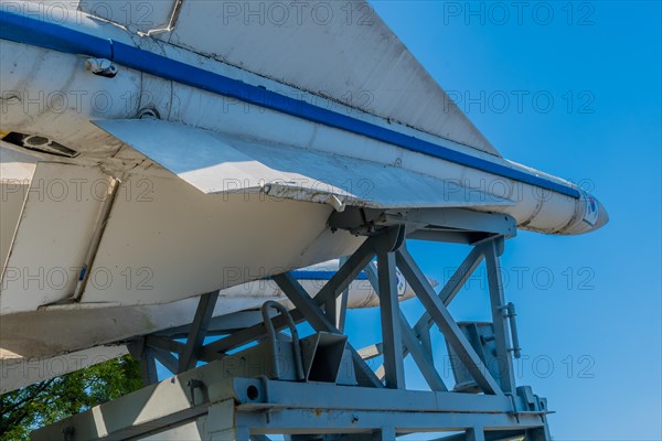 Closeup side view of missiles on steel mounting frame on display in public park