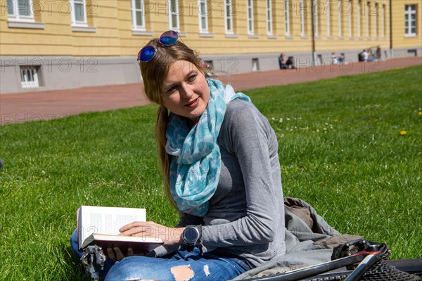 Young woman with bicycle enjoying the spring weather in Karlsruhe Palace Gardens (symbolic image)