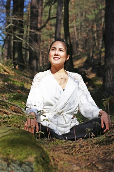 Young woman bathing in the forest (Shinrin Yoku), nature therapy from Japan