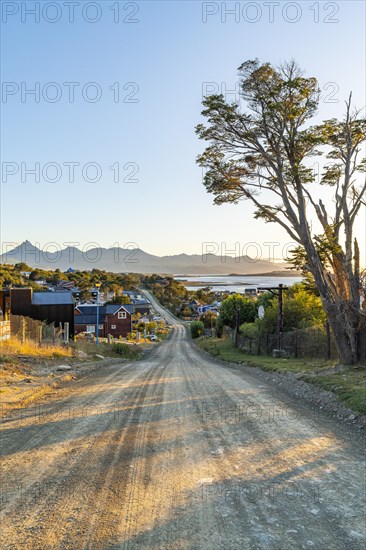 Earth road into the city of Ushuaia, behind the Beagle Channel, Tierra del Fuego Island, Patagonia, Argentina, South America