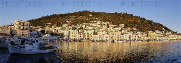 Fishing boats in front of a coastal town, captured in a panorama at dawn, morning light, Gythio, Mani, Peloponnese, Greece, Europe