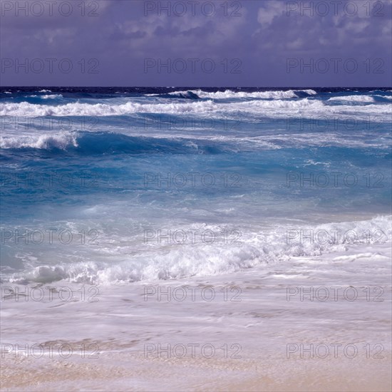 Waves in a storm on La Digue at Grand Anse beach, Seychelles, Africa