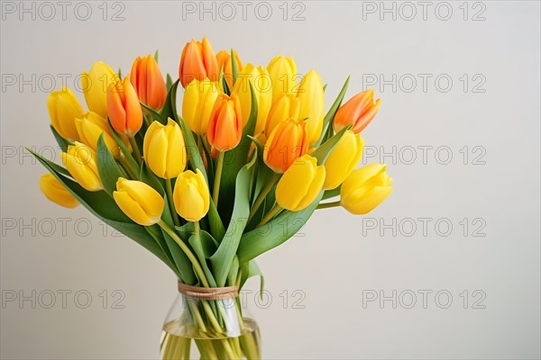 Bouquet of yellow and orange tulip spring flowers in vase. KI generiert, generiert AI generated