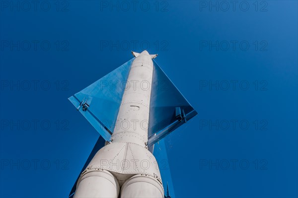 Vertical view of surface to air missile pointing toward blue sky in background