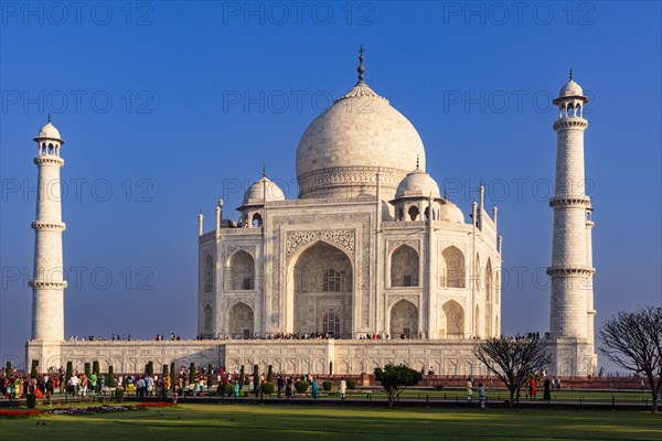 The imposing Taj Mahal surrounded by crowds under a clear sky during the day, Taj Mahal, Agra, India, Asia