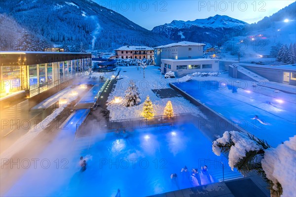 Snow-covered rock spa in winter, thermal bath with Christmas lights at dusk, Bad Gastein, Gastein Valley, Hohe Tauern National Park, Salzburg Province, Austria, Europe