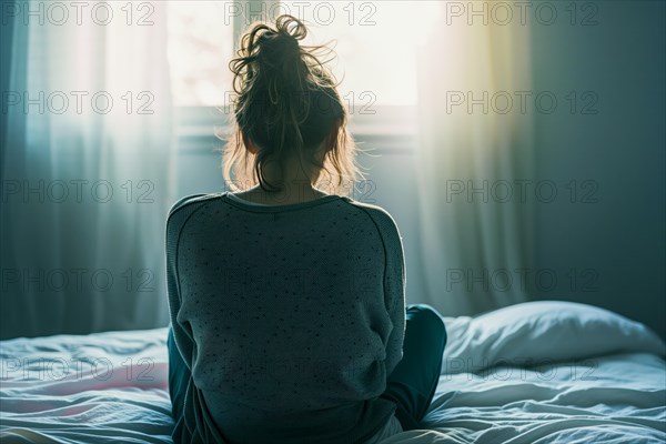 A girl sits on a bed, looking at a window with translucent morning light, symbolising depression and abuse, AI generated, AI generated