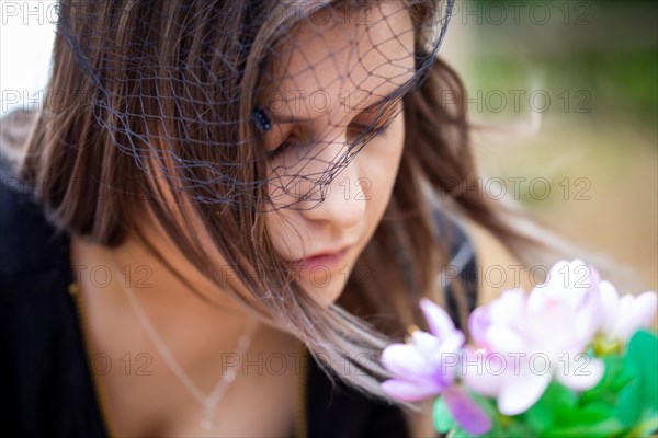 Close-up of a grieving young woman with a mourning veil (symbolic image)