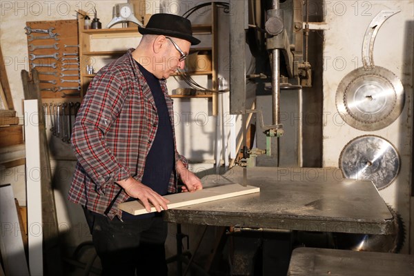 Furniture restorer works with a jigsaw