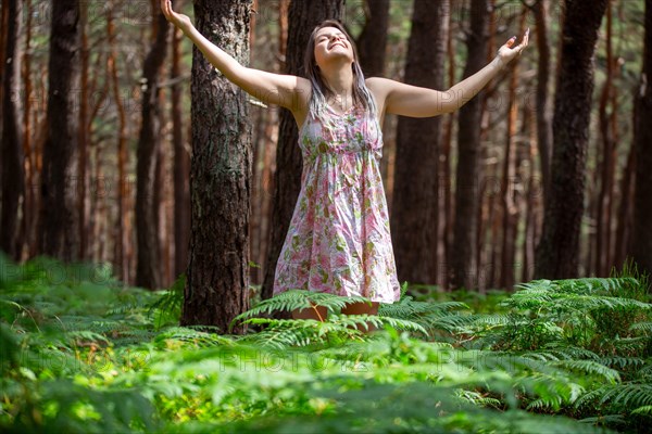 Young woman bathing in the forest (Shinrin Yoku), nature therapy from Japan