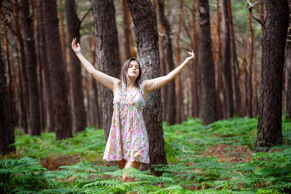 Young woman bathing in the forest (Shinrin Yoku), nature therapy from Japan