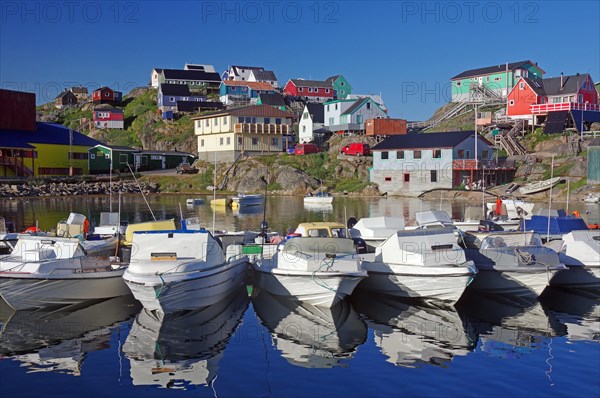 Pleasure boats and colourful houses are reflected in the calm water, Maniitsoq Harbour, Greenland, Denmark, North America