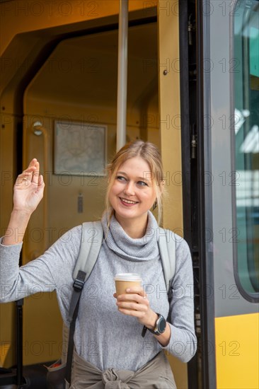 Young woman boarding a train