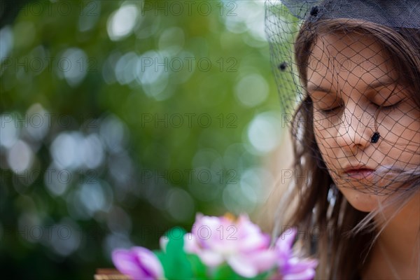 Close-up of a grieving young woman with a mourning veil (symbolic image)