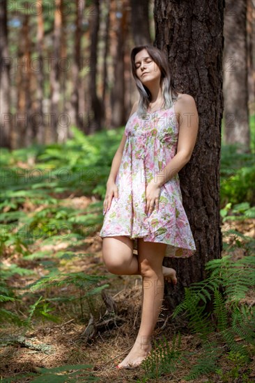 Young woman bathing in the forest (Shinrin Yoku), nature therapy from Japan